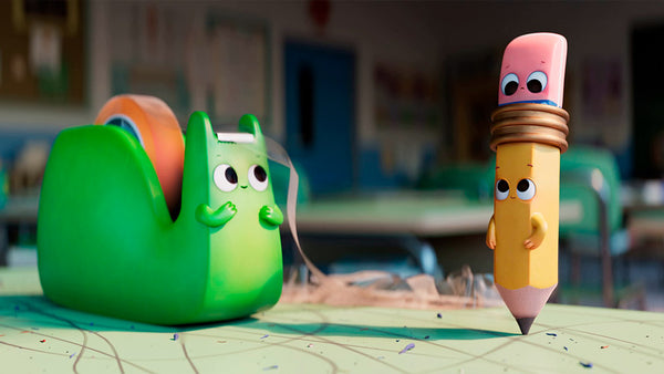 Spencer the pencil next to a green tape dispenser on a school desk